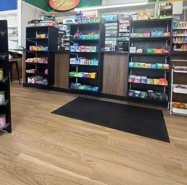 Wide view of the checkout area and front counter shelving