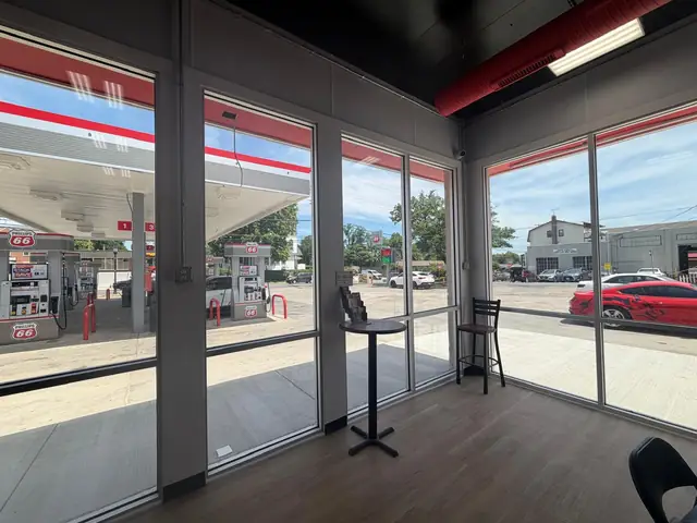 Seating area with new storefront glass looking out to the fuel pumps