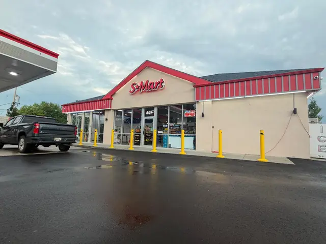 Completed convenience store with lit sign and fuel canopy