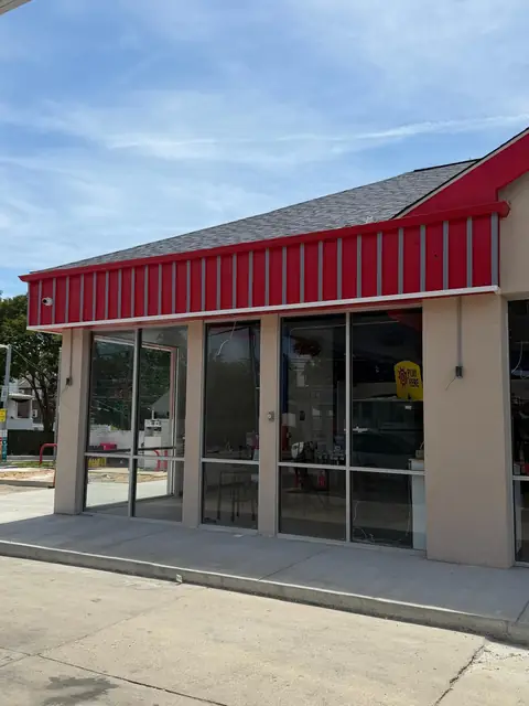 Full height storefront glass along the side of the building