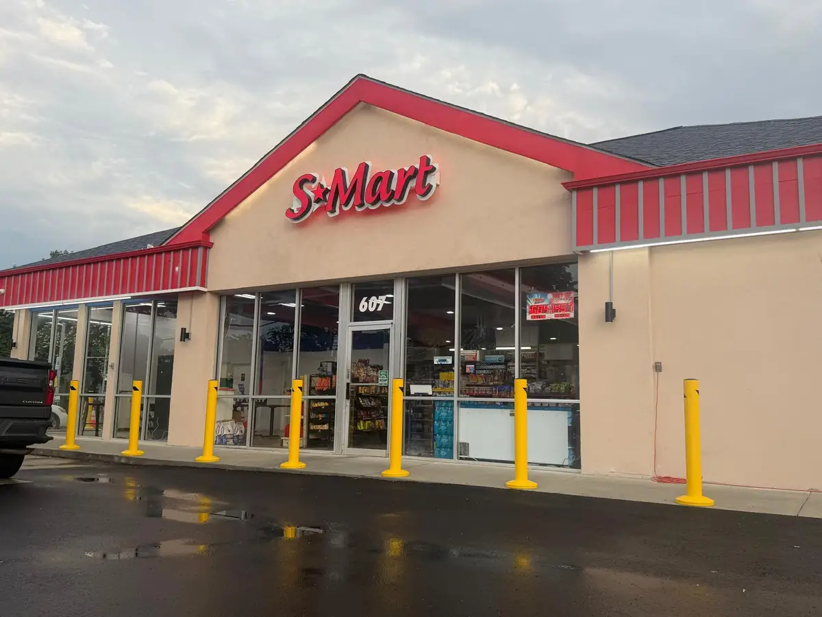 Finished S-Mart storefront lit up at dusk, built by Maryland Builders